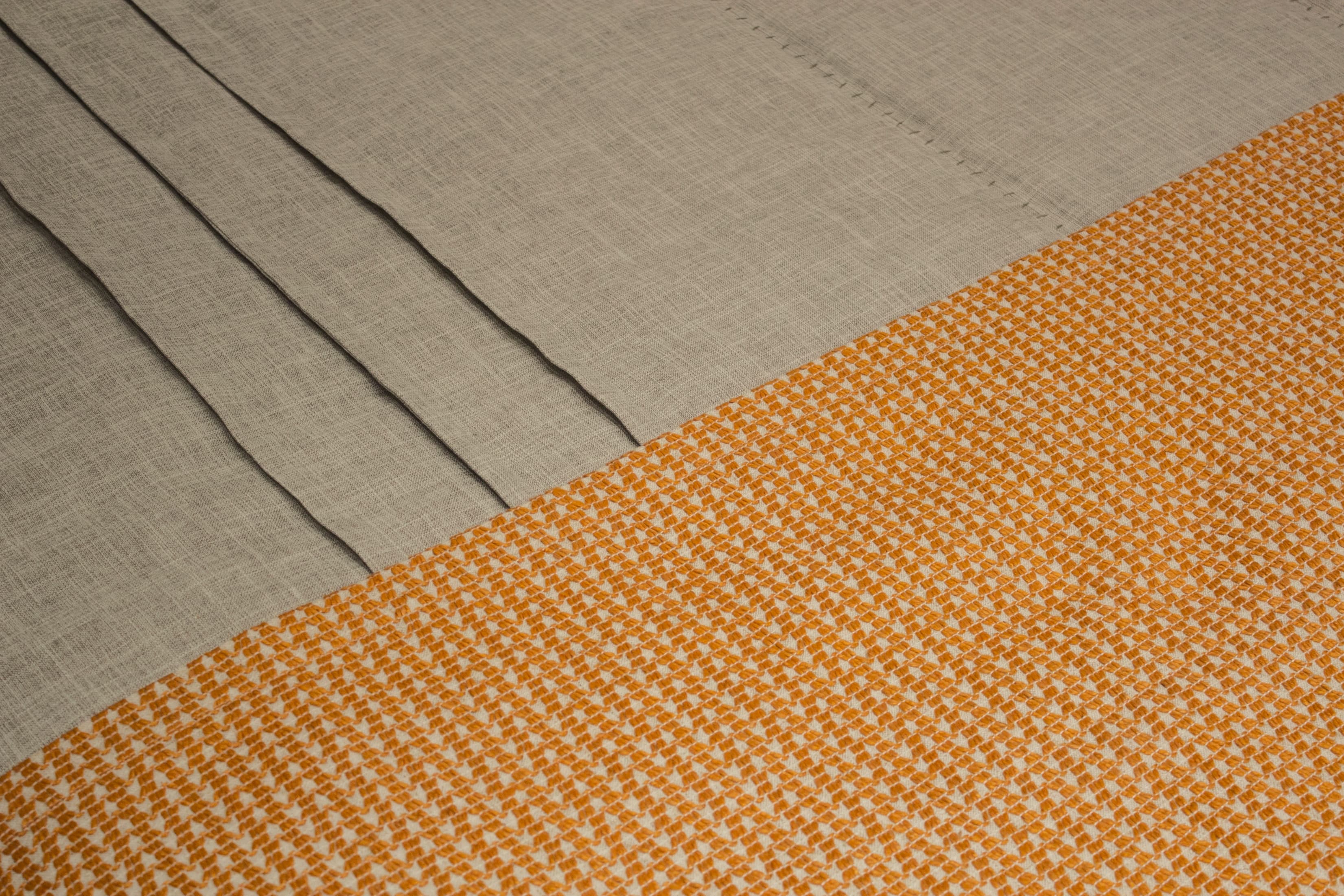 Linen and orange fabric — diagonal composition